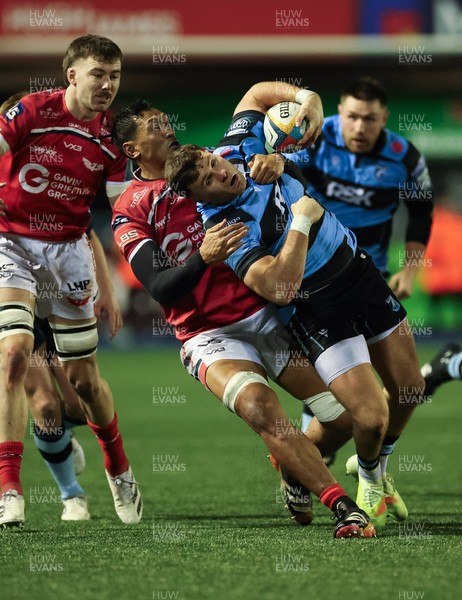 191225 - Cardiff Rugby v Scarlets, United Rugby Championship - Mason Grady of Cardiff Rugby is tackled by Sam Lousi of Scarlets