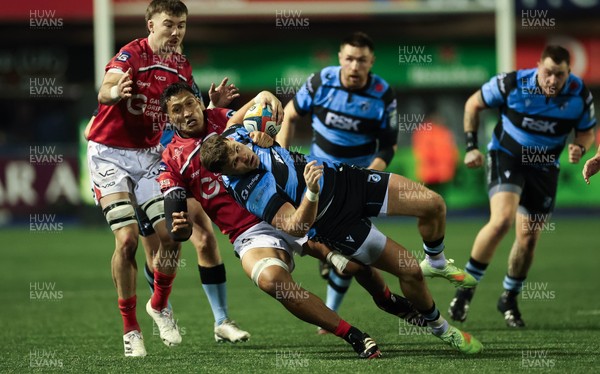 191225 - Cardiff Rugby v Scarlets, United Rugby Championship - Mason Grady of Cardiff Rugby is tackled by Sam Lousi of Scarlets