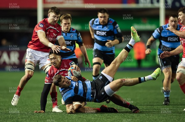 191225 - Cardiff Rugby v Scarlets, United Rugby Championship - Mason Grady of Cardiff Rugby is tackled by Sam Lousi of Scarlets
