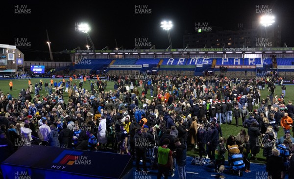 191225 - Cardiff Rugby v Scarlets, United Rugby Championship - Fans take to the Cardiff Arms Park pitch at the end of the match