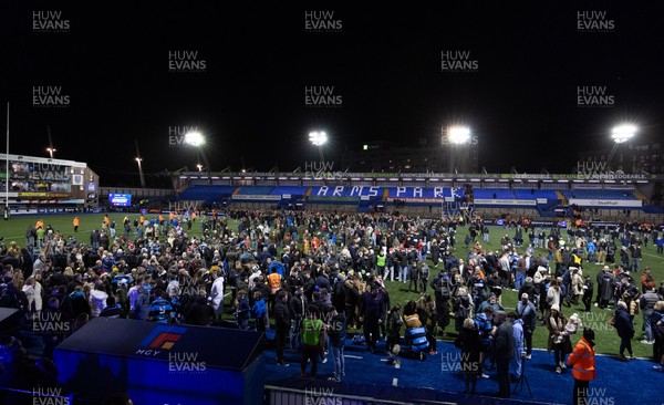 191225 - Cardiff Rugby v Scarlets, United Rugby Championship - Fans take to the Cardiff Arms Park pitch at the end of the match