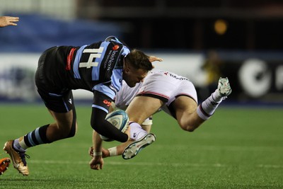 040323 - Cardiff Rugby v Ulster - United Rugby Championship - Owen Lane of Cardiff rugby is tackled by Stewart Moore of Ulster 