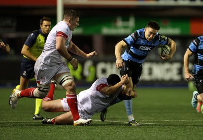 131225 - Cardiff Rugby v Ulster - United Rugby Championship - Josh Adams of Cardiff is tackled by Juarno Augustus of Ulster 