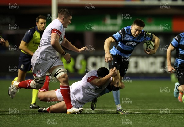 131225 - Cardiff Rugby v Ulster - United Rugby Championship - Josh Adams of Cardiff is tackled by Juarno Augustus of Ulster 