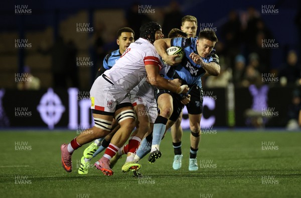 131225 - Cardiff Rugby v Ulster - United Rugby Championship - Josh Adams of Cardiff is tackled by Juarno Augustus of Ulster 