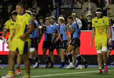 021026 - Cardiff Rugby v Zebre Parma - United Rugby Championship - Tom Bowen of Cardiff celebrates scoring a try with team mates