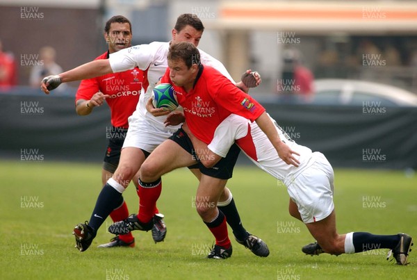 310503 - Wales v England - Cardiff Sevens - IRB Sevens World Series - Wales' Gareth Williams takes on Ugo Moyne (tackler)