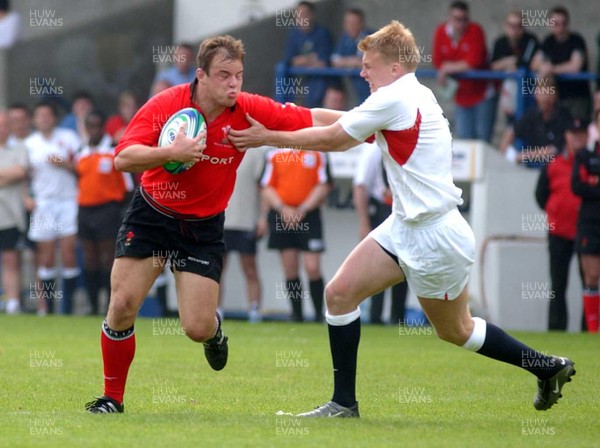 310503 - Wales v England - Cardiff Sevens - IRB Sevens World Series - Wales' Gareth Williams hands off Magnus Lund