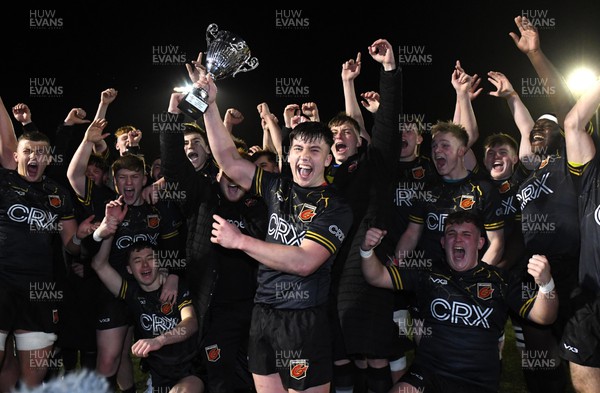 160222 - Cardiff U18 v Dragons U18 - Under 18 Regional Age Grade - Harri Ackerman of Dragons lifts the trophy with team mates