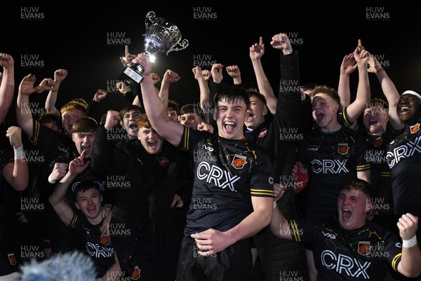 160222 - Cardiff U18 v Dragons U18 - Under 18 Regional Age Grade - Harri Ackerman of Dragons lifts the trophy with team mates
