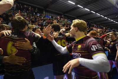 031225 - Cardiff Uni v Cardiff Met - Cardiff Clash - Cardiff Met players celebrate the win at full time with fans