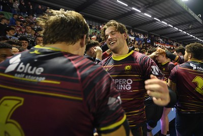 031225 - Cardiff Uni v Cardiff Met - Cardiff Clash - Cardiff Met players celebrate the win at full time with fans