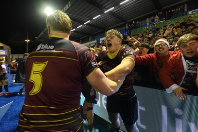 031225 - Cardiff Uni v Cardiff Met - Cardiff Clash - Cardiff Met players celebrate the win at full time with fans