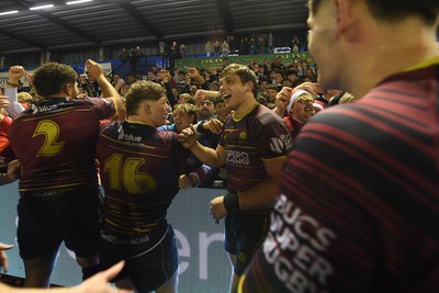 031225 - Cardiff Uni v Cardiff Met - Cardiff Clash - Cardiff Met players celebrate the win at full time with fans