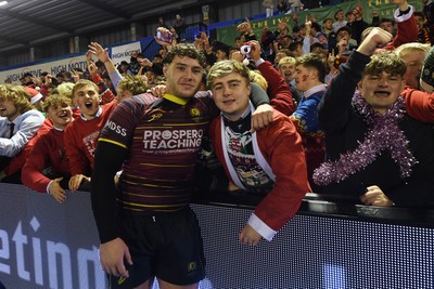 031225 - Cardiff Uni v Cardiff Met - Cardiff Clash - Cardiff Met players celebrate the win at full time with fans
