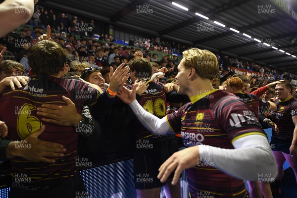 031225 - Cardiff Uni v Cardiff Met - Cardiff Clash - Cardiff Met players celebrate the win at full time with fans