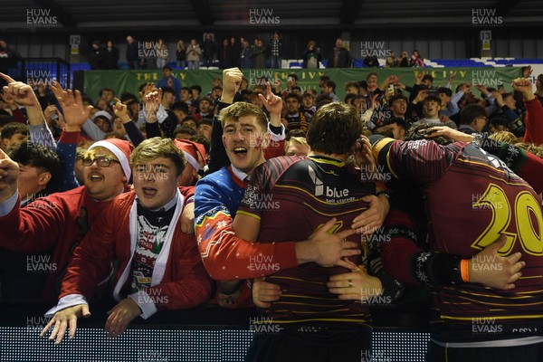 031225 - Cardiff Uni v Cardiff Met - Cardiff Clash - Cardiff Met players celebrate the win at full time with fans