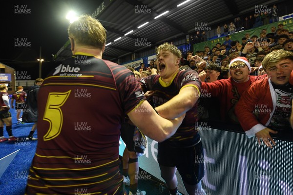 031225 - Cardiff Uni v Cardiff Met - Cardiff Clash - Cardiff Met players celebrate the win at full time with fans