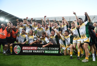 240424 - Cardiff University v Swansea University - Welsh Varsity Mens Match - Swansea University celebrate lifting the trophy after victory over Cardiff University