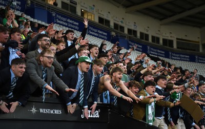 240424 - Cardiff University v Swansea University - Welsh Varsity Mens Match - Supporters of Swansea Uni celebrate after a victory