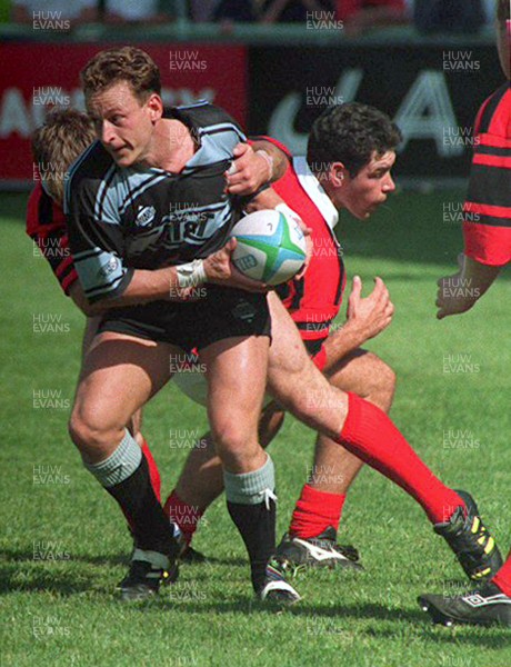 040993 - Cardiff v Aberavon - Heineken League - Jason Hewlett of Cardiff shrugs off a tackle from Chris Kinsey