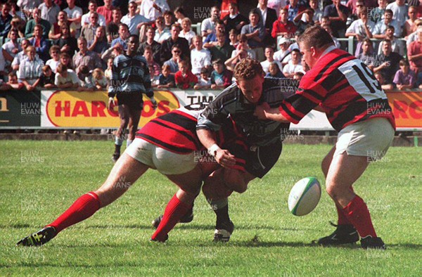 040993 - Cardiff v Aberavon - Heineken League - Jason Hewlett of Cardiff is tackled by Phil Middleton (L) and Justin Hughes (R) of Aberavon