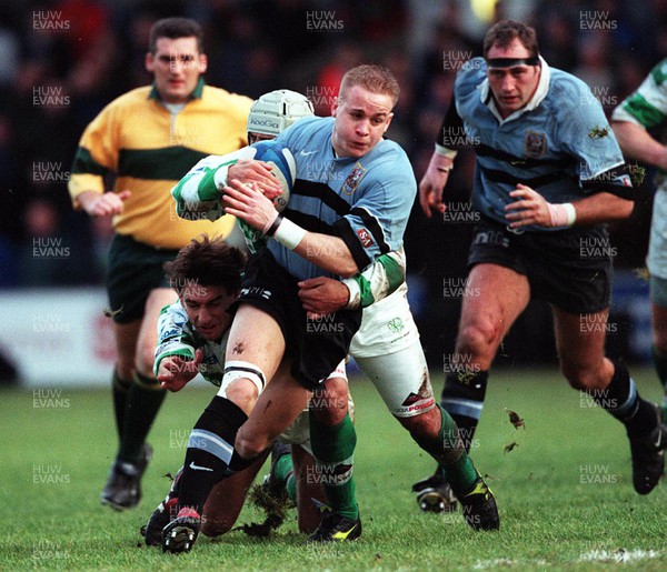 111299 - Cardiff v Benetton Treviso - Heineken Cup - Cardiff's Ryan Powell is tackled by Andy Moore and Andre Sgorlon