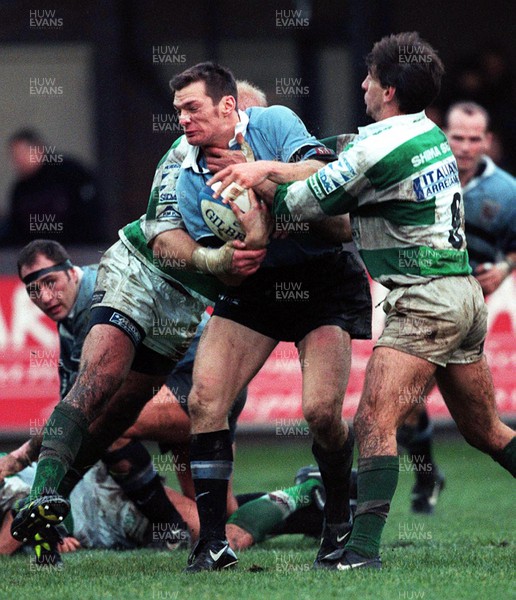 111299 - Cardiff v Benetton Treviso - Heineken Cup - Cardiff's Liam Botham is held by Andy Moore, right, and Adriaan Richter