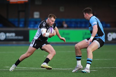 270124 - Cardiff v Bridgend - Indigo Group Premiership - Tommy Morgan of Bridgend Ravens steps inside Jason Harris of Cardiff