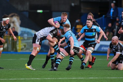 270124 - Cardiff v Bridgend - Indigo Group Premiership - Freddie Barnes of Cardiff is tackled by Jack Pope of Bridgend Ravens