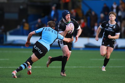 270124 - Cardiff v Bridgend - Indigo Group Premiership - Mike Powell of Bridgend Ravens is tackled by Joe Goodchild of Cardiff