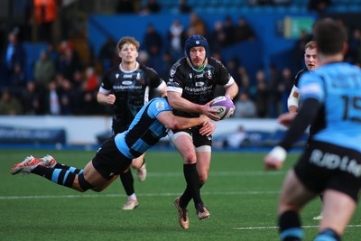 270124 - Cardiff v Bridgend - Indigo Group Premiership - Mike Powell of Bridgend Ravens is tackled by Joe Goodchild of Cardiff