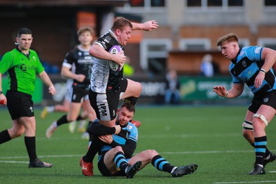 270124 - Cardiff v Bridgend - Indigo Group Premiership - Evan Yeardley of Bridgend Ravens is tackled by Tom Habberfield of Cardiff