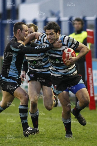 261209 - Cardiff RFC v Glamorgan Wanderers RFC - Principality Premiership - Glamorgan Wanderers' Charlie Johnson is tackled by Cardiff's Gareth Davies