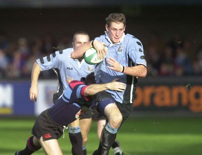 271001 - Cardiff v Glasgow - Heineken Cup - Cardiff's Jamie Robinson in full flight despite tackle by Glenn Metcalfe