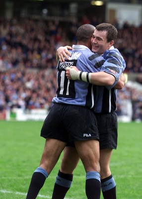 271001 - Cardiff v Glasgow - Heineken Cup - Cardiff's Iestyn Harris at the end of the game with a hug from Anthony Sullivan