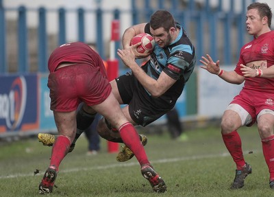 180212 Cardiff RFC v Llanelli RFC - Swalec Cup -Cardiff's Dan Parteidge is tackled by Llanelli's Tom Wilson