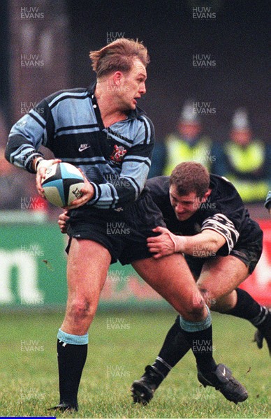 231295 - Cardiff v Neath - Mike Hall of Cardiff is tackled by Leigh Davies