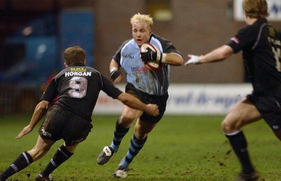 280203 - Cardiff v Neath - Welsh Premiership - Cardiff's Ryan Powell takes on Patrick Horgan