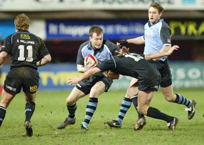 280203 - Cardiff v Neath - Welsh Premiership - Cardiff's Nick Walne is tackled by Allan Bateman