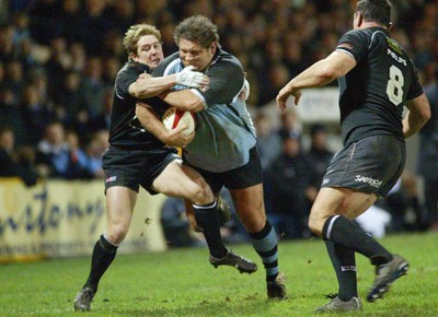 280203 - Cardiff v Neath - Welsh Premiership - Cardiff's Peter Rogers is tackled by Shane Williams