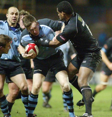 280203 - Cardiff v Neath - Welsh Premiership - Cardiff's Nick Walne is tackled by Alfie Mocelutu