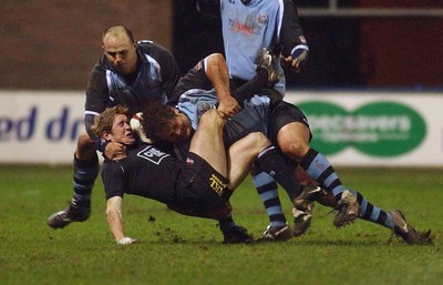 280203 - Cardiff v Neath - Welsh Premiership - Neath's Shane Williams is upended by Peter Rogers