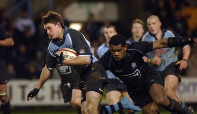 280203 - Cardiff v Neath - Welsh Premiership - Cardiff's Jamie Robinson attempts to break away from Alfie Mocelutu