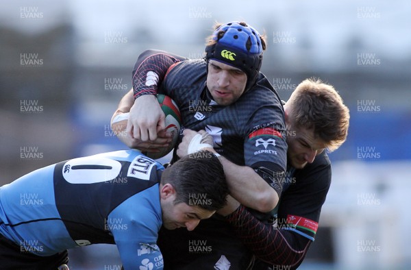 300116 - Cardiff RFC v Neath RFC - Principality Premiership -Alex Humfrey of Neath is tackled by James Thomas(10) and Miles Normandale of Cardiff