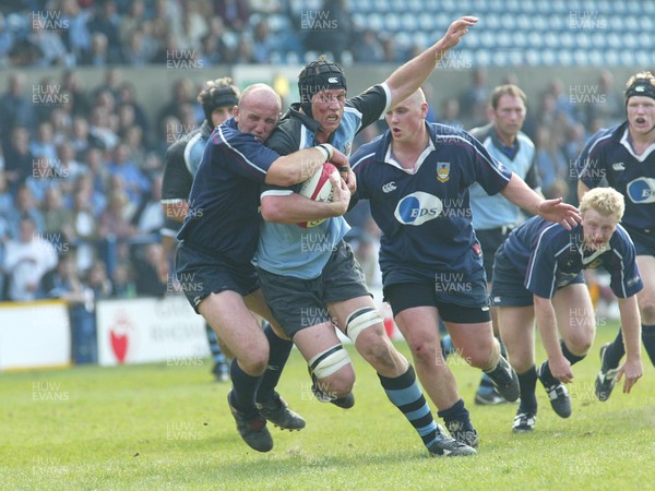 120403 - Cardiff v Swansea - Welsh Premiership - Cardiff's Heino Senekal is tackled by Richard Francis