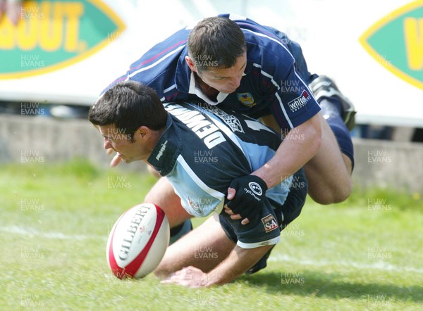 120403 - Cardiff v Swansea - Welsh Premiership - Cardiff's Dean Dewdney is tackled just short of the line by Richard Rees