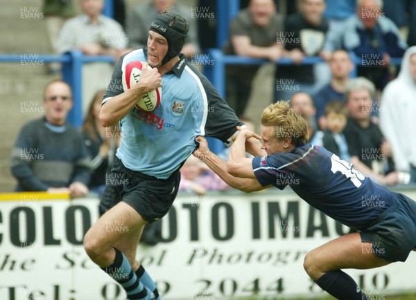 120403 - Cardiff v Swansea - Welsh Premiership - Cardiff's Luke Tait breaks Chris Shelmerdine's tackle to score try