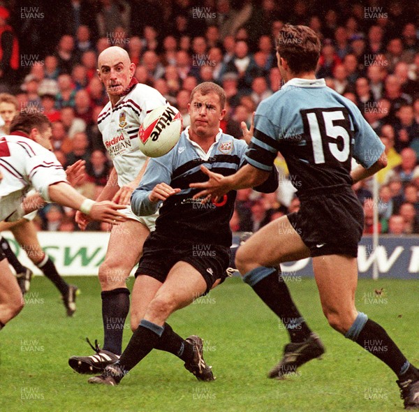 260497 - Cardiff v Swansea - SWALEC Cup Final -  Cardiff's Leigh Davies slips the ball to Justin Thomas as Steve Moore (lt) and Alan Reynolds tackle