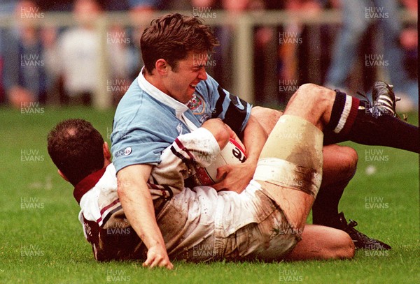 260497 - Cardiff v Swansea - SWALEC Cup Final -  Cardiff's Justin Thomas is stopped from grounding the ball for a try by Simon Davies